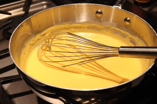 whisking a cheese sauce